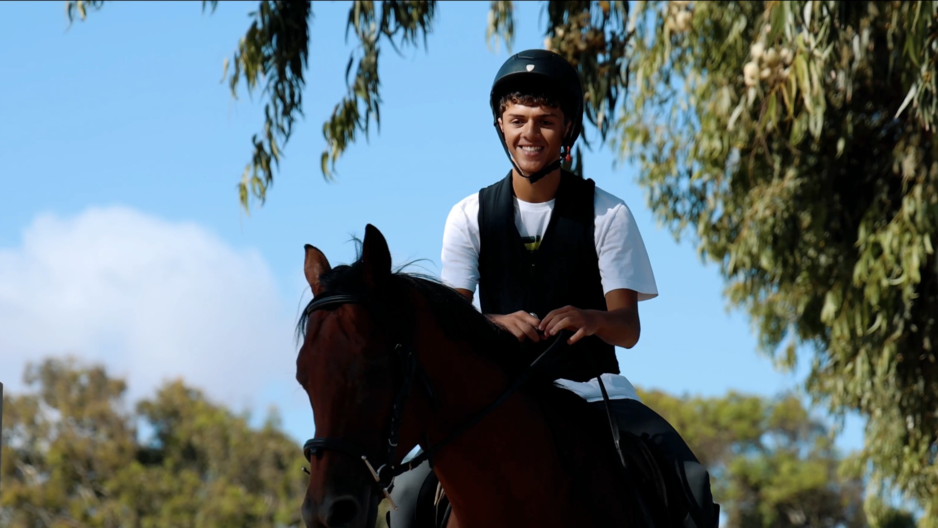 Yanis riding a horse during equestrian training