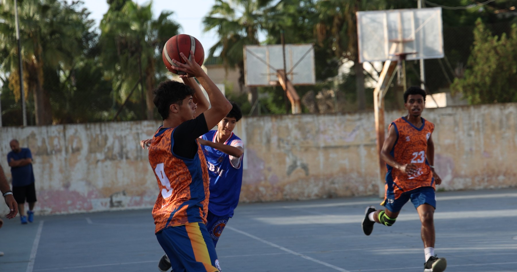 Yanis raising the ball during a basketball play